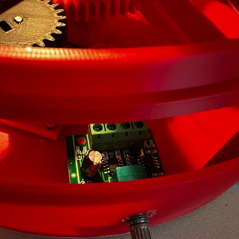 PWM controller and adjustment shaft mounted through the wall of the red base.