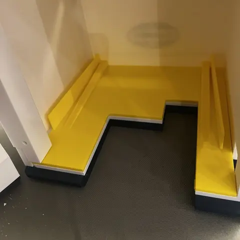 A yellow test cradle compensating for the printer’s irregular shape